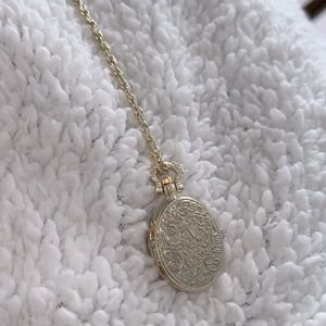 Gold locket with clock